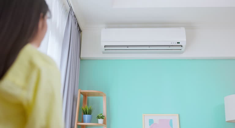 Ductless AC unit cooling a comfortable modern bedroom
